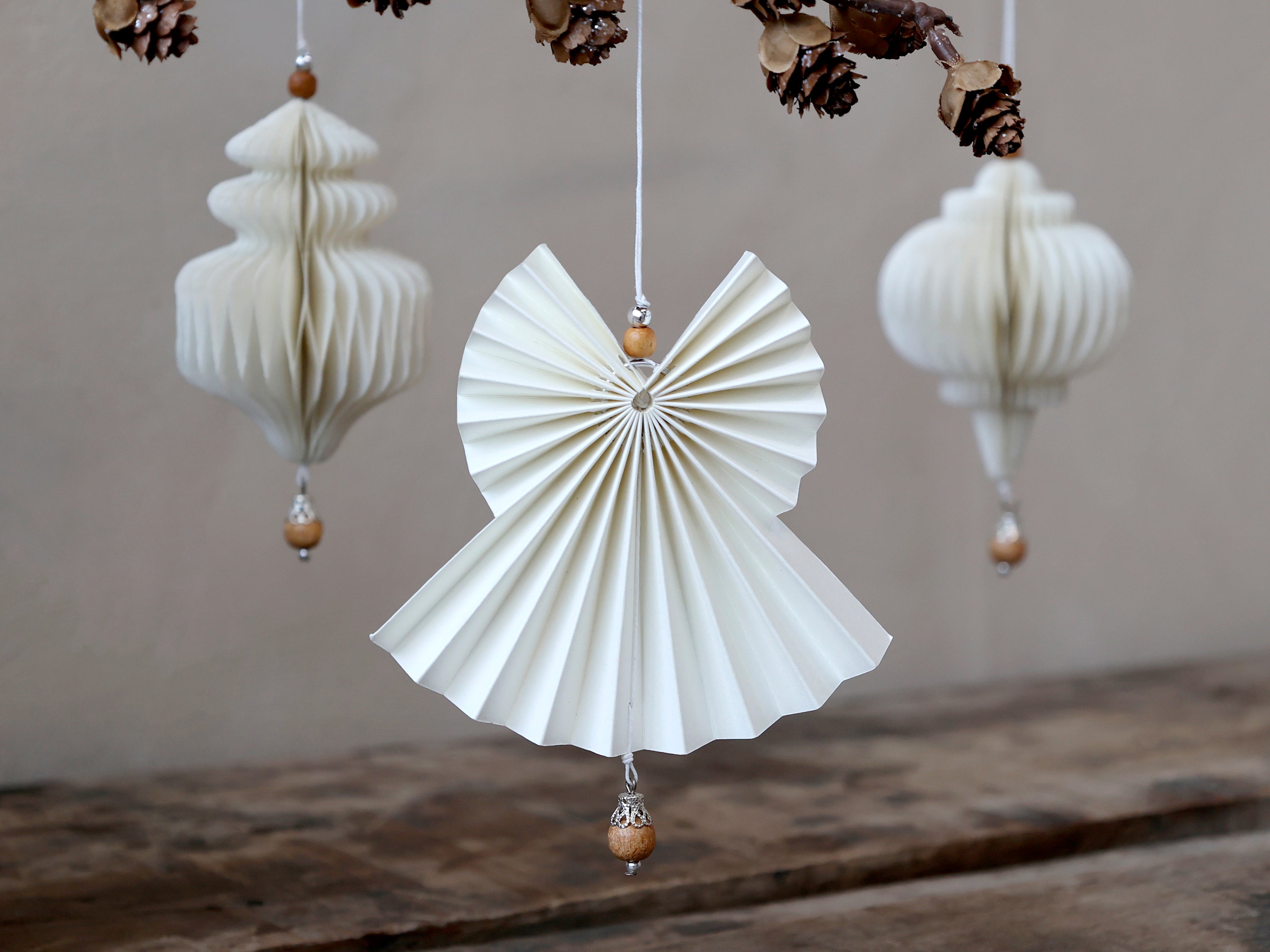 Paper angel with wooden pearl