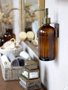 Holder for dispenser bottle in antique brass
