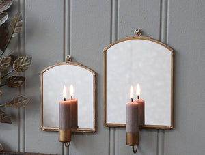 Antique brass mirror with candle holder